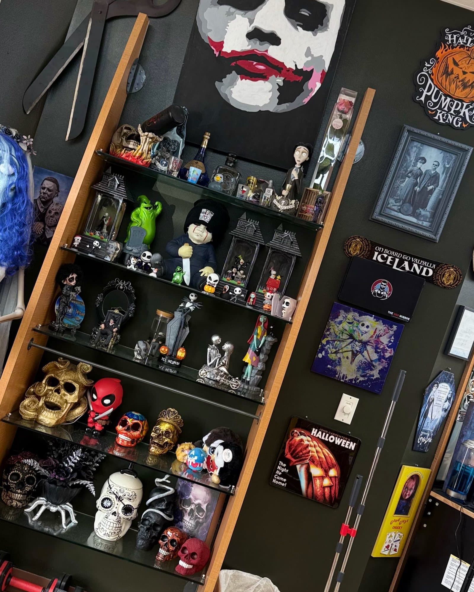 Phantom Fades horror shelf — a Joker portrait above skulls, masks, and Halloween collectibles